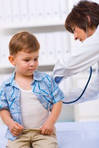 Doctor examining child